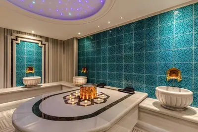 a bathroom with blue tiled walls and a round tub at Beethoven Senfoni Hotel in Istanbul