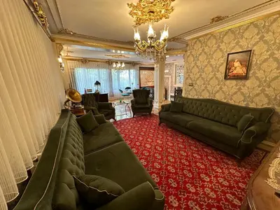a living room with a couch and a chandelier at TAHTAKALE KONAK HOTEL Private & Luxury in Bursa