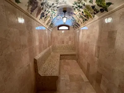 a tiled hallway with a bench in a building at TAHTAKALE KONAK HOTEL Private & Luxury in Bursa