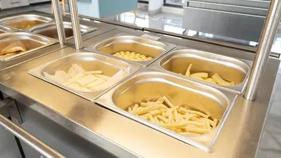 a kitchen with several trays of food in a cafeteria at Yalıköy Deniz Otel Istanbul in Yalıköy
