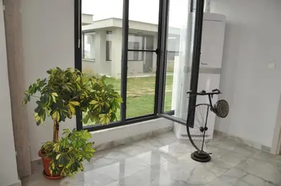 a room with two potted plants in front of a window at Yalıköy Deniz Otel Istanbul in Yalıköy