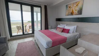 a hotel room with a bed and a balcony at Yalıköy Deniz Otel Istanbul in Yalıköy