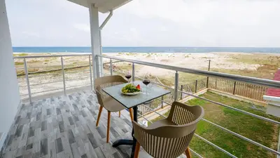 a balcony with a table and chairs and the beach at Yalıköy Deniz Otel Istanbul in Yalıköy