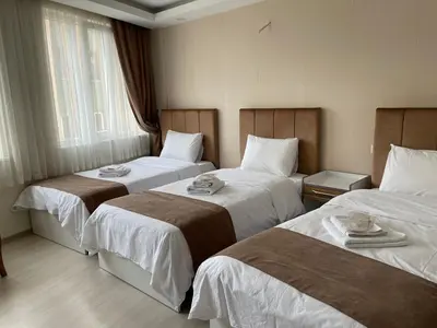 a hotel room with two beds with dishes on them at Bursa Malkoc Hotel in Bursa