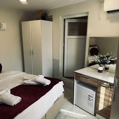 a bedroom with a bed and a large mirror at Bursa Malkoc Hotel in Bursa