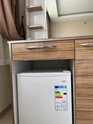 a white refrigerator in a kitchen with a drawer at Bursa Malkoc Hotel in Bursa