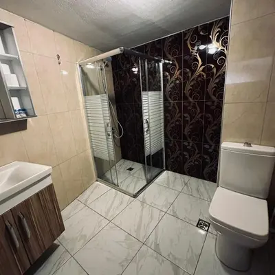 a bathroom with a shower and a toilet at Bursa Malkoc Hotel in Bursa