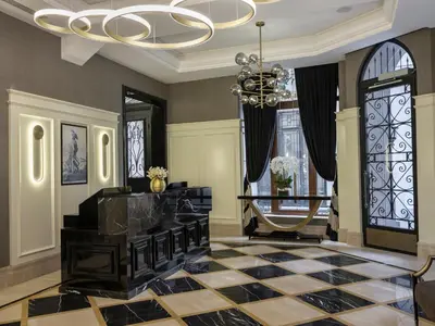 a living room with a chandelier and a checkerboard floor at Azzap Hotel Galata in Istanbul