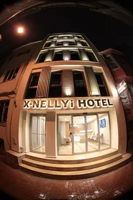 a building with a hotel sign on the side of it at X-NELLYİ HOTEL in Istanbul