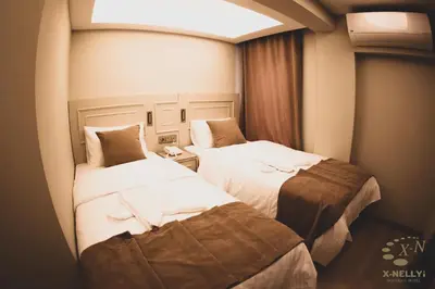 a hotel room with two beds and a window at X-NELLYİ HOTEL in Istanbul