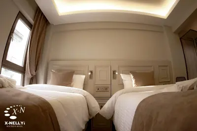 a bedroom with two beds and a window at X-NELLYİ HOTEL in Istanbul