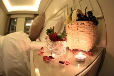 a table with a candle and a basket of fruit at X-NELLYİ HOTEL in Istanbul