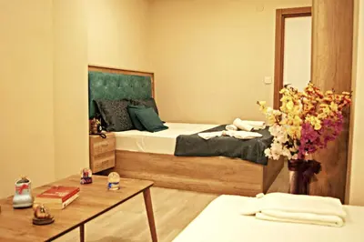 a bedroom with a bed and a vase of flowers at Destinia Pera in Istanbul