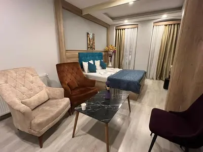 a living room with a couch and a chair at Destinia Pera in Istanbul