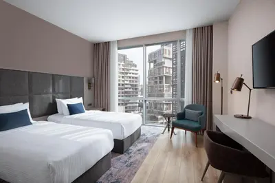 a hotel room with two beds and a window at Delta Hotels by Marriott Istanbul Vadi in Istanbul