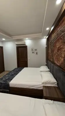 a bedroom with a bed and a brick wall at Han Suite Hotel in Istanbul
