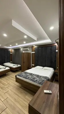 a hotel room with two beds and a table at Han Suite Hotel in Istanbul