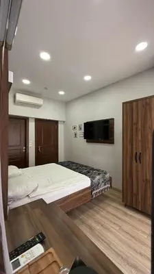a bedroom with a large bed and a flat screen tv at Han Suite Hotel in Istanbul