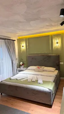 a bedroom with a large bed with two towels on it at GV Suites Galata in Istanbul