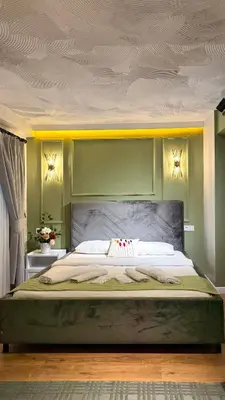 a bedroom with a large bed with green walls at GV Suites Galata in Istanbul