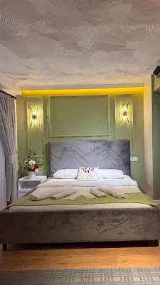 a large bed in a bedroom with green walls at GV Suites Galata in Istanbul