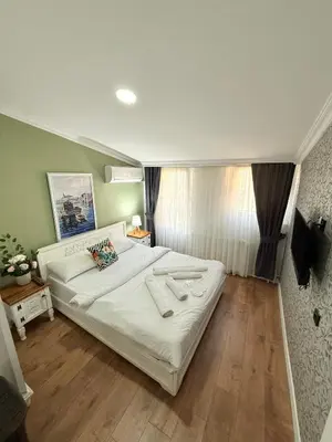 a bedroom with a large bed with white sheets at GV Suites Galata in Istanbul