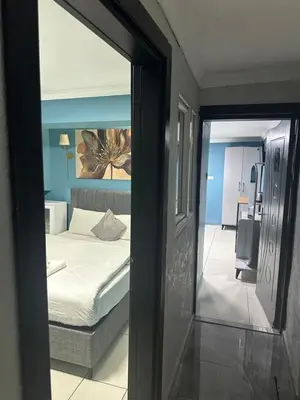 a view of a bedroom with a bed and a mirror at Ada Apart Hotel in Istanbul