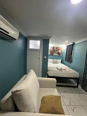 a small room with two beds and a couch at Ada Apart Hotel in Istanbul