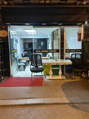a table and chairs in front of a store window at Ada Apart Hotel in Istanbul
