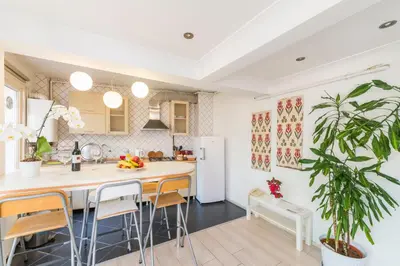 a kitchen with a large island with bar stools at Istanbul Amedros Home in Istanbul