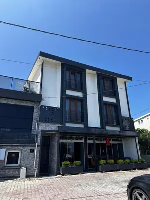 a black and white building on a street at KILIÇ MOTEL in Istanbul