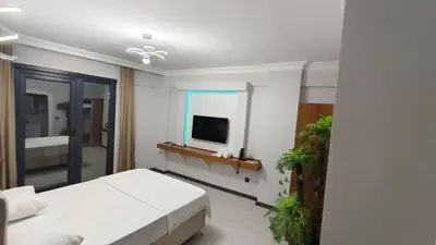 a bedroom with a bed and a tv on a wall at KILIÇ MOTEL in Istanbul
