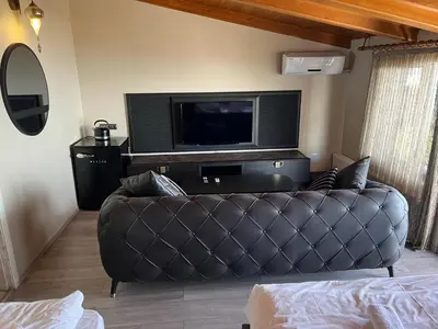 a living room with a couch and a flat screen tv at Cheers Lighthouse in Istanbul