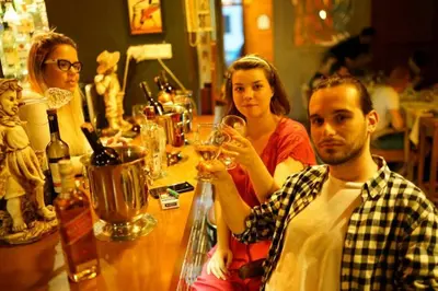 a group of people sitting at a table with wine glasses at Cheers Lighthouse in Istanbul
