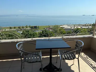 a table and two chairs on a balcony with the ocean at Cheers Lighthouse in Istanbul