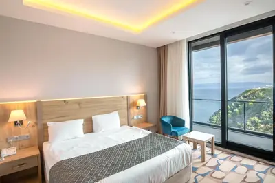 a hotel room with a bed and a large window at BLUE MUDANYA HOTEL in Bursa