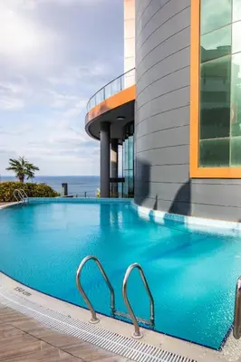a swimming pool in front of a building at BLUE MUDANYA HOTEL in Bursa