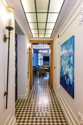 a hallway with a tile floor and a painting on the wall at Petros Hotel in Istanbul