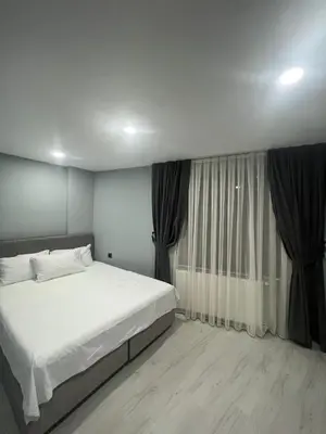 a bedroom with a white bed and a window at Seaway Hotel İstanbul in Istanbul
