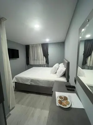 a hotel room with a bed and a plate of donuts at Seaway Hotel İstanbul in Istanbul