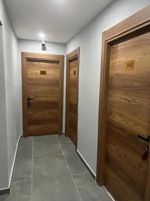 a hallway with two wooden doors and a tile floor at Seaway Hotel İstanbul in Istanbul