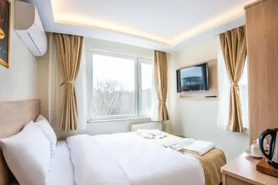 a hotel room with a bed and a window at Royal Bosphorus Hotel & SPA Hamam in Istanbul