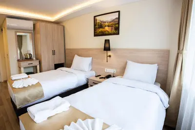 a hotel room with two beds and a table at Royal Bosphorus Hotel & SPA Hamam in Istanbul