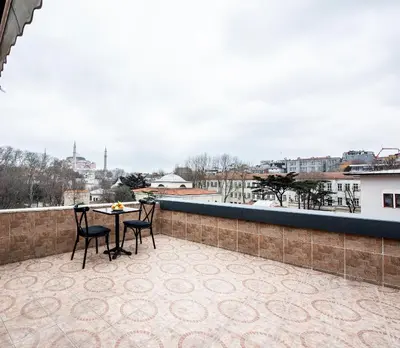 a patio with a table and chairs on a roof at Royal Bosphorus Hotel & SPA Hamam in Istanbul