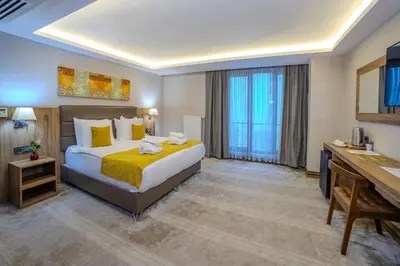 a hotel room with a bed and a desk at Royal Termal Hotel in Bursa