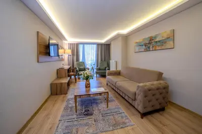 a living room with a couch and a table at Royal Termal Hotel in Bursa