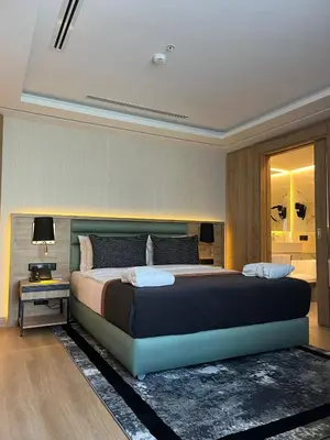 a bedroom with a large bed and a table at Vital Hotel Fulya Istanbul Sisli in Istanbul
