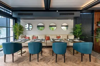 a dining room with a table and blue chairs at Vital Hotel Fulya Istanbul Sisli in Istanbul