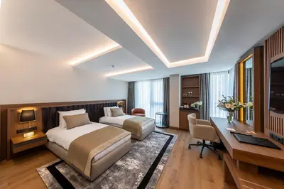 a hotel room with two beds and a desk and a computer at Vital Hotel Fulya Istanbul Sisli in Istanbul