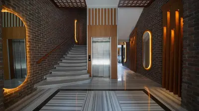 a hallway with a staircase and a brick wall at Grand Sirkeci Hotel in Istanbul